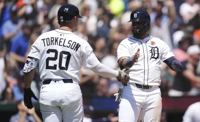 Detroit Tigers' Gleyber Torres, right, celebrates scoring with Spencer Torkelson (20) against the San Francisco Giants in the fifth inning during a baseball game, Monday, May 26, 2025, in Detroit. (AP Photo/Paul Sancya)