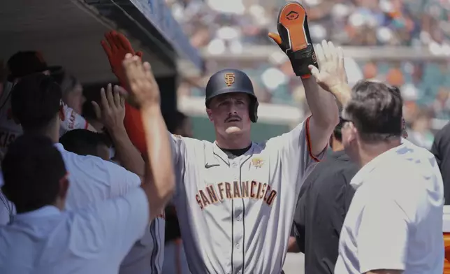 San Francisco Giants' Matt Chapman celebrates scoring against the Detroit Tigers in the sixth inning during a baseball game, Monday, May 26, 2025, in Detroit. (AP Photo/Paul Sancya)