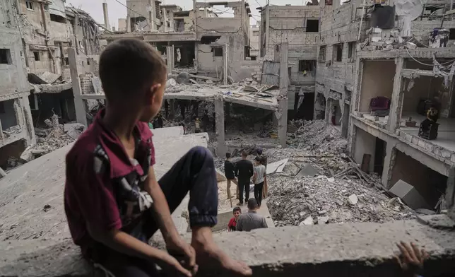 Palestinians inspect the rubble of the Al-Lahham family's home, destroyed by Israeli airstrikes in Khan Younis, Gaza Strip, on Thursday, May 15, 2025. (AP Photo/Abdel Kareem Hana)