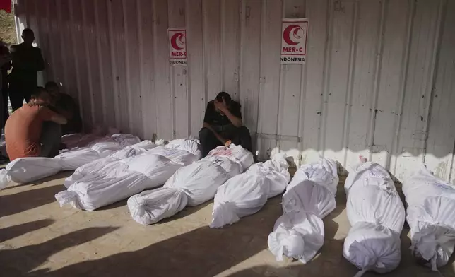 Palestinians mourn their relatives killed in an Israeli airstrikes in Jabalia, northern Gaza Strip, on Wednesday, May 14, 2025. According to local hospitals, 48 people were killed in the strikes, including 22 children. (AP Photo/Jehad Alshrafi)