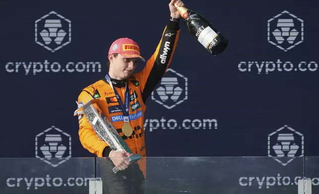 McLaren driver Oscar Piastri of Australia celebrates on the podium after winning the Formula One Miami Grand Prix auto race Sunday, May 4, 2025, in Miami Gardens. Fla. (AP Photo/Marta Lavandier)