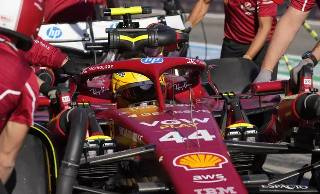 Ferrari driver Lewis Hamilton of Britain gets pushed back into his garage during the second free practice at the Enzo and Dino Ferrari racetrack, ahead the Italy's Emilia Romagna Formula One Grand Prix, in Imola, Italy, Friday, May 16, 2025. (AP Photo/Luca Bruno)