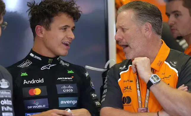 McLaren driver Lando Norris of Britain, left, talks to Zak Brown, McLaren chief, in his garage after the second free practice at the Enzo and Dino Ferrari racetrack, ahead the Italy's Emilia Romagna Formula One Grand Prix, in Imola, Italy, Friday, May 16, 2025. (AP Photo/Luca Bruno)
