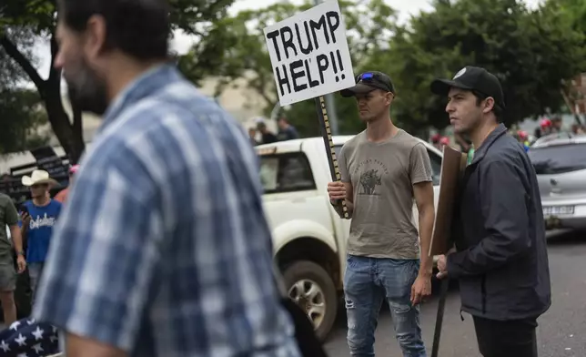 FILE - White South Africans demonstrate in support of U.S. President Donald Trump in front of the U.S. embassy in Pretoria, South Africa, Saturday, Feb. 15, 2025. (AP Photo/Jerome Delay, File)