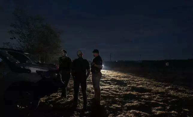Members of Afriforum, a neighborhood and farm security group, assemble before a patrol in Bashewa area in the east of Pretoria, South Africa, Thursday, March 29, 2025. (AP Photo/Alet Pretorius)