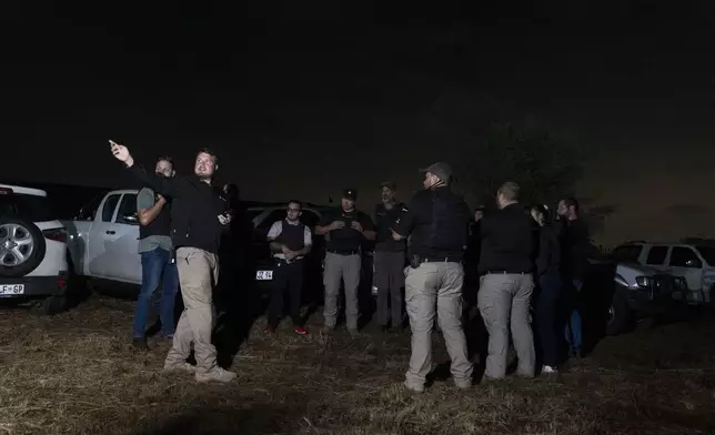 Members of Afriforum, a neighborhood and farm security group, assemble before a patrol in Bashewa area in the east of Pretoria, South Africa, Thursday, March 29, 2025. (AP Photo/Alet Pretorius)