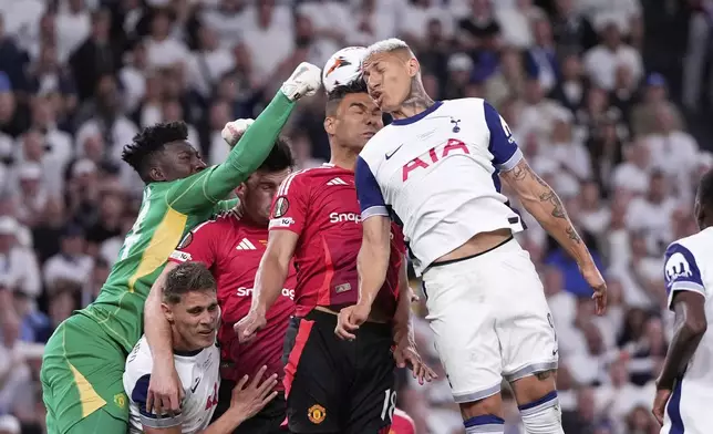 Tottenham's Richarlison, right, challenges for the ball with Manchester United's Casemiro, center, and Manchester United's goalkeeper Andre Onana, left, during the Europa League final soccer match between Tottenham Hotspur and Manchester United at the San Mames Stadium in Bilbao, Spain, Wednesday, May 21, 2025. (AP Photo/Jose Breton)