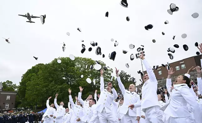 New ensigns toss their caps in celebration at the conclusion of commencement exercises at the United States Coast Guard Academy, Wednesday, May 21, 2025 in New London, Conn. (AP Photo/Jessica Hill)
