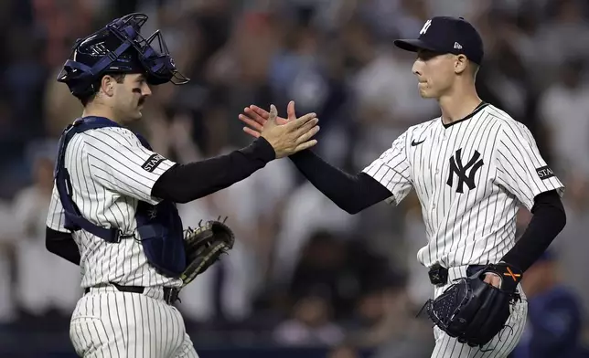 New York Yankees pitcher Luke Weaver, right, and catcher Austin Wells, left, celebrate after a baseball game against the Tampa Bay Rays, Friday, May 2, 2025, in New York. (AP Photo/Adam Hunger)
