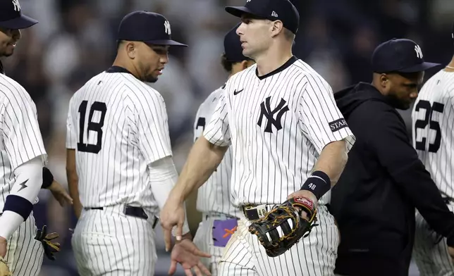 New York Yankees first baseman Paul Goldschmidt, center front, celebrates with teammates after a baseball game against the Tampa Bay Rays, Friday, May 2, 2025, in New York. (AP Photo/Adam Hunger)