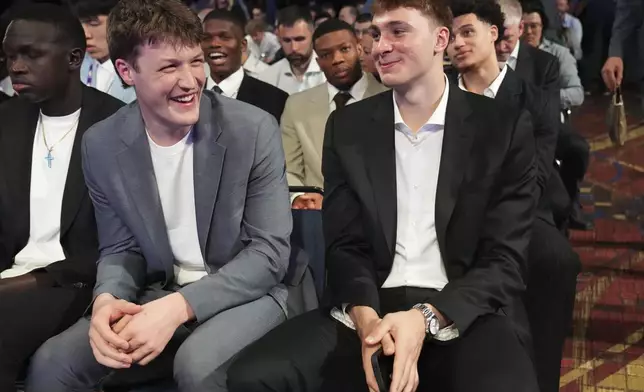 Duke's Kon Knueppel, left, and Cooper Flagg, right, smile at the NBA basketball draft lottery in Chicago, Monday, May 12, 2025. (AP Photo/Nam Y. Huh)