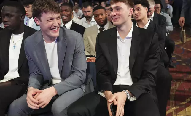 Duke's Kon Knueppel, left, and Cooper Flagg, right, smile at the NBA basketball draft lottery in Chicago, Monday, May 12, 2025. (AP Photo/Nam Y. Huh)
