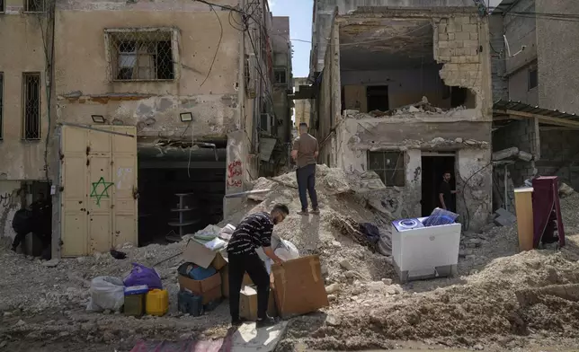 Residents of the now evacuated Palestinian refugee camp of Tulkarem return to collect belongings before the destruction of their homes as Israeli forces prepare to carry out the demolition of 116 homes across the two refugee camps of the Israeli occupied West Bank city of Tulkarem, Friday, May 2, 2025. (AP Photo/Nasser Nasser)