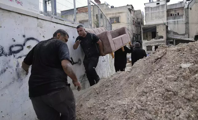 Residents of the now evacuated refugee camp of Tulkarem return to collect belongings before the destruction of their homes as Israeli forces prepare to carry out the demolition of 116 homes across the two refugee camps of the Israeli occupied West Bank city of Tulkarem, Friday, May 2, 2025. (AP Photo/Nasser Nasser)