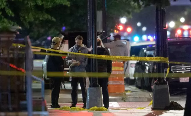 Law enforcement work the scene after two staff members of the Israeli Embassy in Washington were shot and killed outside the Capital Jewish Museum, Thursday, May 22, 2025, in Washington. (AP Photo/Rod Lamkey, Jr.)