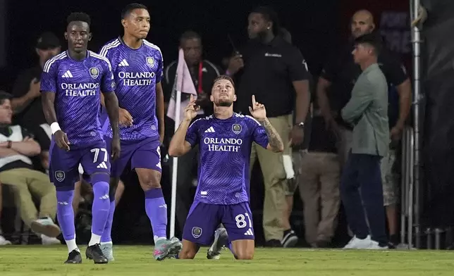 Orlando City forward Marco Pasalic (87) celebrates after scoring his side's second goal against Inter Miami during the second half of an MLS soccer match, Sunday, May 18, 2025, in Fort Lauderdale, Fla. (AP Photo/Rebecca Blackwell)