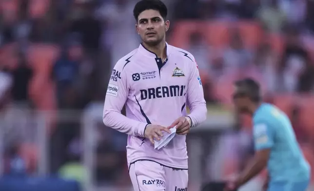 Gujarat Titans' captain Shubman Gill walks after the toss during the Indian Premier League cricket match between Gujarat Titans and Lucknow Super Giants at Narendra Modi Stadium in Ahmedabad, India, Thursday, May 22, 2025. (AP Photo/Ajit Solanki)