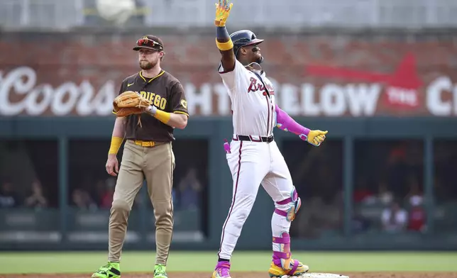 Atlanta Braves' Ronald Acuna Jr., right, reacts after hitting a double in the fifth inning of a baseball game against the San Diego Padres, Sunday, May 25, 2025, in Atlanta. (AP Photo/Colin Hubbard)