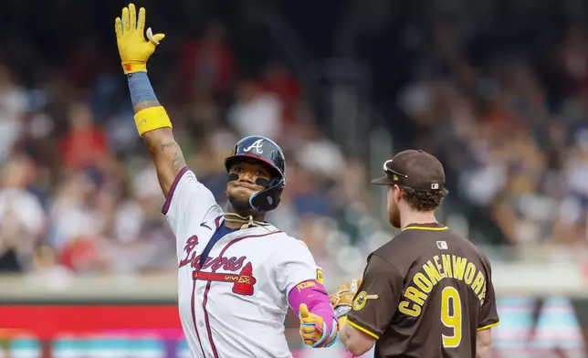 Atlanta Braves' Ronald Acuña Jr. (13) reacts with teammates after hitting a double during the fifth inning of a baseball game against the San Diego Padres on Sunday, May 25, 2025, in Atlanta. (Miguel Martinez/Atlanta Journal-Constitution via AP)