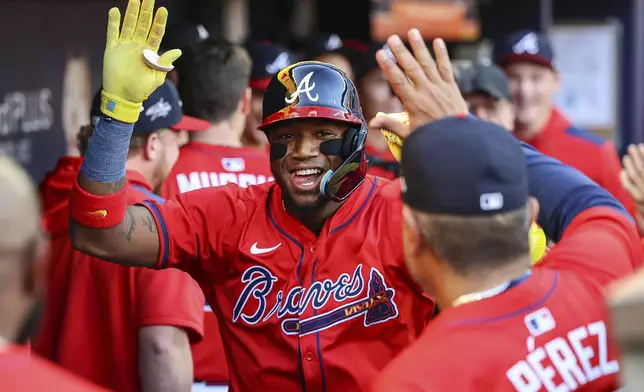 Atlanta Braves' Ronald Acuna Jr. celebrates in the dugout after hitting a home run in the first inning of a baseball game against the San Diego Padres, Friday, May 23, 2025, in Atlanta. (AP Photo/Colin Hubbard)