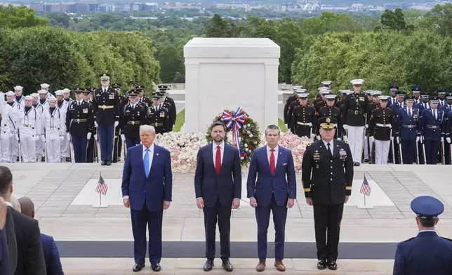 President Donald Trump, Vice President JD Vance, Secretary of Defense Pete Hegseth and Major General Trevor Bredenkamp, commanding general of the Joint Task Force-National Capital Region and the U.S. Army Military District of Washington, right, attend a Memorial Day wreath laying ceremony at Arlington National Cemetery, in Arlington, Va., Monday, May 26, 2025. (AP Photo/Jacquelyn Martin)