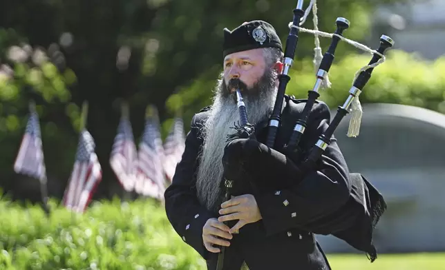 Bagpiper Timothy Gatehouse participates in an annual Memorial Day observance at Sandyvale Cemetery in Johnstown, Pa., Monday, May 26, 2025. (John Rucosky/The Tribune-Democrat via AP)