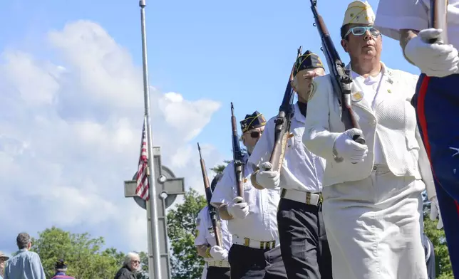 Gold Star Mother Regina Meckle joins the American Legion Color Guard as they visit memorials and cemeteries in Brattleboro, Vt., on Monday, May 26, 2025, on Memorial Day to honor the lives of soldiers who have died. (Kristopher Radder/The Brattleboro Reformer via AP)