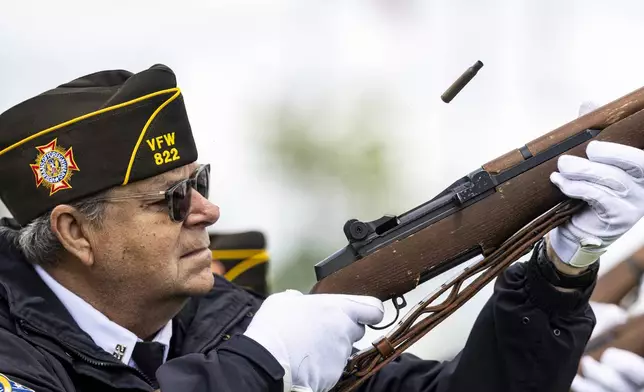 A member of the VFW Post 822 Flint Honor Guard Team completes a rifle salute during a Memorial Day ceremony on Sunday, May 25, 2025, at Great Lakes National Cemetery in Holly Township, Mich. (Ayrton Breckenridge/The Flint Journal via AP)