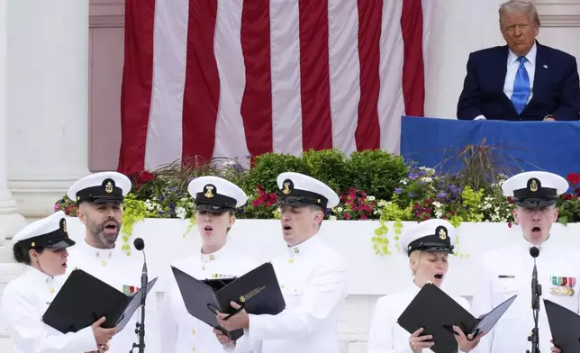 President Donald Trump listens to the U.S. Navy Sea Chanters sing, before delivering the Memorial Day Address at the 157th National Memorial Day Observance at Arlington National Cemetery, Monday, May 26, 2025, in Arlington, Va. (AP Photo/Julia Demaree Nikhinson)