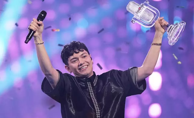 Winner of the Eurovision Song Contest JJ from Austria holds up the trophy onstage, he won with the song "Wasted Love" during the Grand Final of the 69th Eurovision Song Contest, in Basel, Switzerland, Saturday, May 17, 2025. (AP Photo/Martin Meissner)
