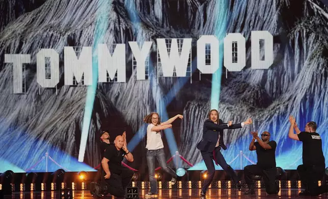 Tommy Cash from Estonia, center, performs the song "Espresso Macchiato" during the Grand Final of the 69th Eurovision Song Contest, in Basel, Switzerland, Saturday, May 17, 2025. (AP Photo/Martin Meissner)