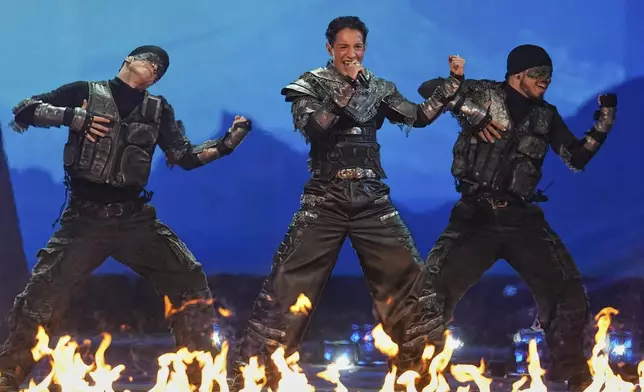 Kyle Alessandro from Norway, center, performs the song "Lighter" during the Grand Final of the 69th Eurovision Song Contest, in Basel, Switzerland, Saturday, May 17, 2025. (AP Photo/Martin Meissner)