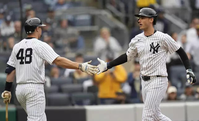 New York Yankees' Cody Bellinger, right, celebrates after his two-run home run with Paul Goldschmidt (48) during the sixth inning of a baseball game against the Tampa Bay Rays, Sunday, May 4, 2025, in New York. (AP Photo/Seth Wenig)