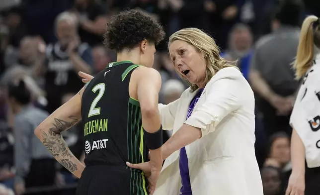 Minnesota Lynx head coach Cheryl Reeve talks with guard Natisha Hiedeman (2) during a timeout in the first half of a WNBA basketball game against the Dallas Wings, Wednesday, May 21, 2025, in Minneapolis. (AP Photo/Abbie Parr)
