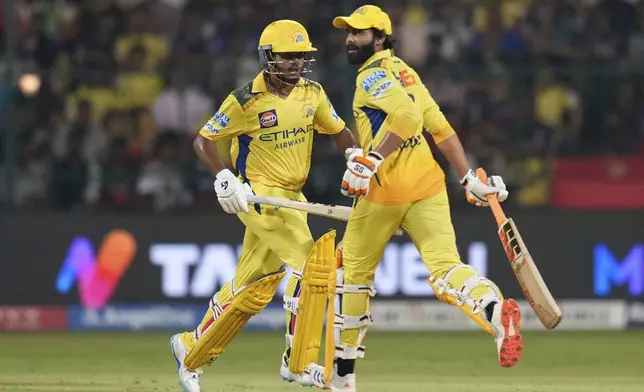Chennai Super Kings Ayush Mhatre, left, and batting partner Ravindra Jadeja run between the wickets to score during the Indian Premier League cricket match between Royal Challengers Bengaluru and Chennai Super Kings at Chinnaswamy Stadium in Bengaluru, India, Saturday, May 3, 2025. (AP Photo/Aijaz Rahi)