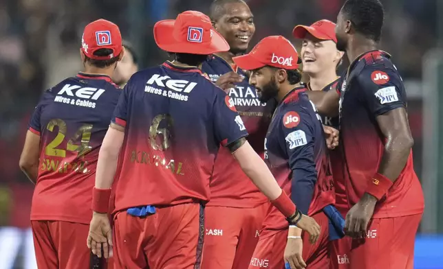 Royal Challengers Bengaluru's Lungi Ngidi, center, celebrates with teammates after the dismissal of Chennai Super Kings' Sam Curran during the Indian Premier League cricket match between Royal Challengers Bengaluru and Chennai Super Kings at Chinnaswamy Stadium in Bengaluru, India, Saturday, May 3, 2025. (AP Photo/Aijaz Rahi)