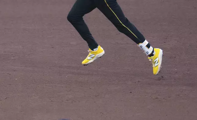 Pittsburgh Pirates' Jared Triolo, top, rounds the bases after hitting a solo home run off Atlanta Braves pitcher Bryce Elder, (55) during the sixth inning of a baseball game in Pittsburgh, Friday, May 9, 2025. (AP Photo/Gene J. Puskar)