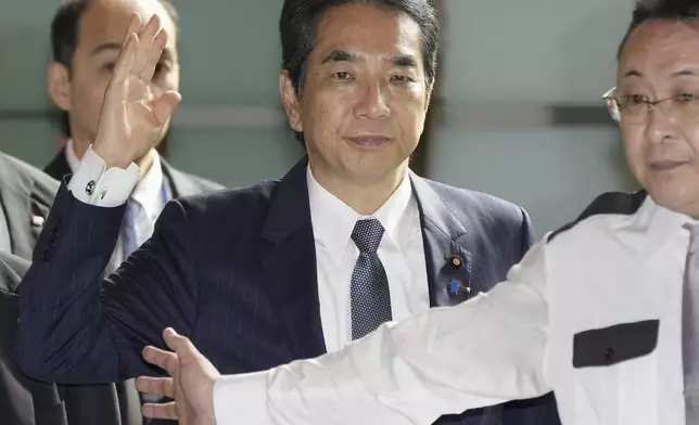 Japan's Agriculture Minister Taku Eto, center, arrives at the prime minister's office in Tokyo Wednesday, May 21, 2025. (Kyodo News via AP)