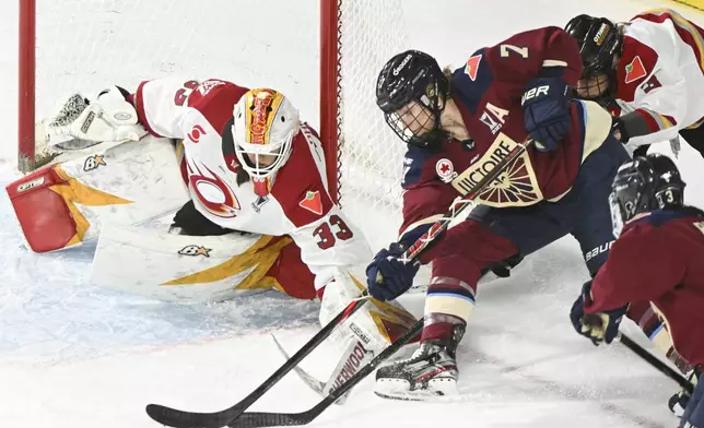 Montreal Victoire's Laura Stacey (7) tries a wraparound against Ottawa Charge goaltender Gwyneth Philips (33) during third overtime period PWHL hockey playoff action in Laval, Quebec, Sunday, May 11, 2025. (Graham Hughes/The Canadian Press via AP)