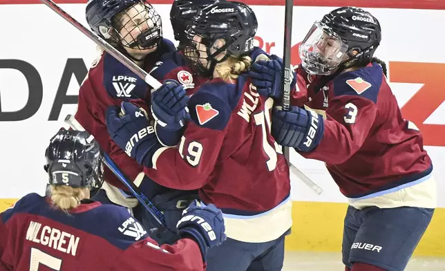 Montreal Victoire's Kristin O'Neill (43) celebrates with teammates after scoring against the Ottawa Charge during first-period PWHL hockey playoff action in Laval, Quebec, Sunday, May 11, 2025. (Graham Hughes/The Canadian Press via AP)