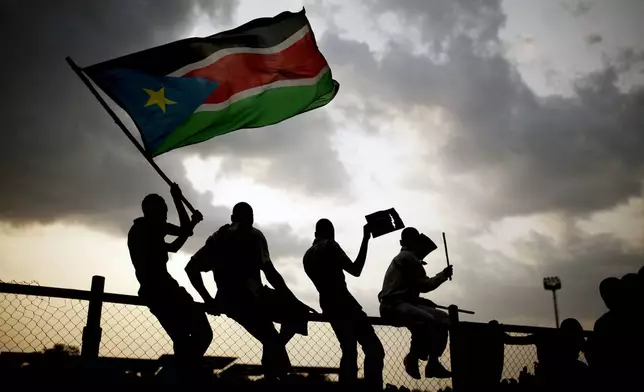FILE - In this Sunday, July 10, 2011 file photo, Southern Sudanese wave the national flag in the capital Juba. (AP Photo/Pete Muller, File)
