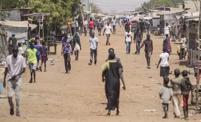 FILE - Internally displaced people walk along a street in Juba, South Sudan, Thursday, Feb. 13, 2025. (AP Photo/Brian Inganga, File)