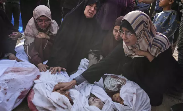 Palestinians mourn children from their families who were killed in Israeli airstrikes in Jabalia, in the northern Gaza Strip, on Wednesday, May 14, 2025. According to local hospitals, the strikes killed 48 people, including 22 children. (AP Photo/Jehad Alshrafi)