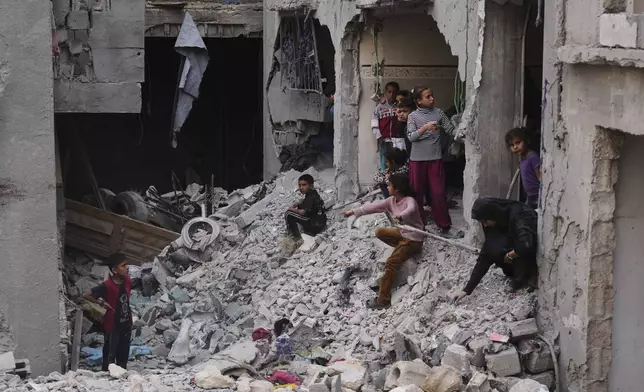 Palestinians inspect the rubble of the Al-Lahham family's home, destroyed by Israeli airstrikes in Khan Younis, Gaza Strip, on Thursday, May 15, 2025. (AP Photo/Abdel Kareem Hana)
