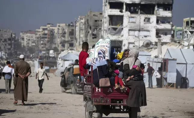 Displaced Palestinians fleeing Beit Lahia amid ongoing Israeli military operations in the Gaza Strip arrive in Jabalia, northern Gaza, on Friday, May 16, 2025. (AP Photo/Jehad Alshrafi)