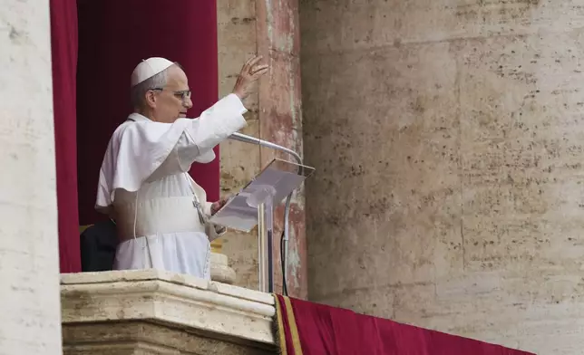 Pope Leo XIV appears at the central balcony of St. Peter's Basilica for his first Sunday blessing after his election, in St. Peter's Square at the Vatican, Sunday May 11, 2025. (AP Photo/Domenico Stinellis)