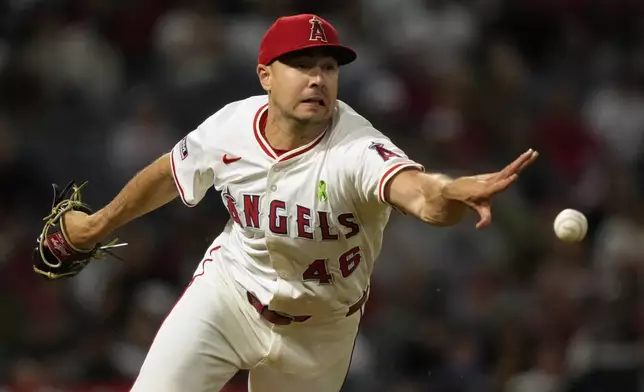 Los Angeles Angels relief pitcher Brock Burke flips the ball to first in an attempt to get Miami Marlins' Ronny Simon during the sixth inning of a baseball game Saturday, May 24, 2025, in Anaheim, Calif. Simon was safe at first on the play. (AP Photo/Mark J. Terrill)