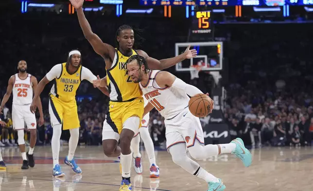 New York Knicks guard Jalen Brunson (11) drives against Indiana Pacers guard Andrew Nembhard (2) during the third quarter of Game 2 of the NBA basketball Eastern Conference final, Friday, May 23, 2025, in New York. (AP Photo/Frank Franklin II)