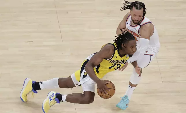 Indiana Pacers forward Aaron Nesmith (23) drives against New York Knicks guard Jalen Brunson (11) during the fourth quarter of Game 2 of the NBA basketball Eastern Conference final, Friday, May 23, 2025, in New York. (AP Photo/Adam Hunger)
