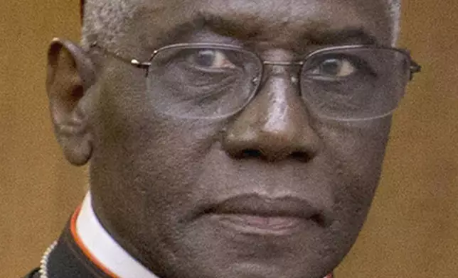 FILE - Cardinal Robert Sarah, prefect of the Congregation for Divine Worship and the Discipline of the Sacraments, arrives in Rome, Oct. 14, 2015. (AP Photo/Andrew Medichini, File)